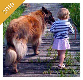 Child walking dog on boardwalk from 2010